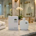 Lacoste White Eau De Toilette 100ml bottle and box on a marble counter
