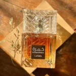 Lattafa Khamrah Eau De Parfum 100ml bottle in warm golden light